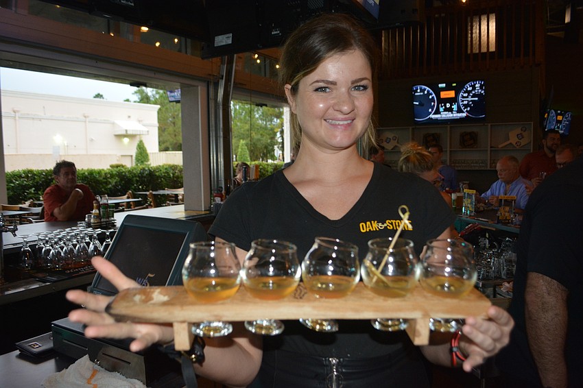 Manager Alex Scott has her hands filled with craft cocktails.