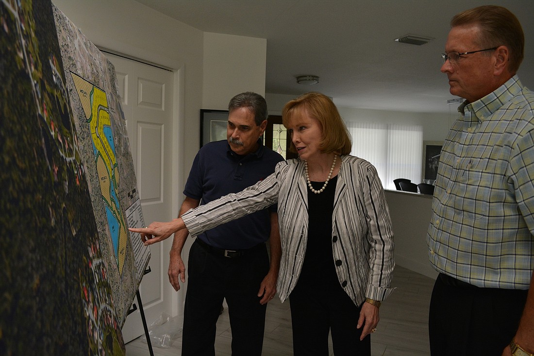 Brenda Russell, center, says development of the proposed park property, a projected called Myara, leaves little connectivity for wildlife even if built using a clustered style of development. Gary Hebert, left, and Phil St. John