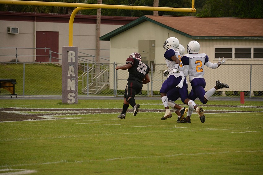 Ali Boyce steps into the end zone ahead of three Booker defenders.