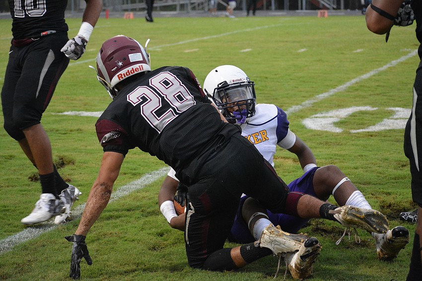 Riverview defender Yunes Mezroub stands while Talik Keaton, after sliding to a stop, looks toward a referee.