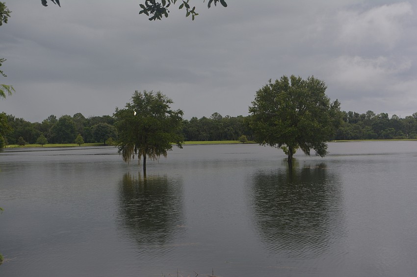 Retention ponds and lakes were overflowing their banks Sunday morning. Photo by Jay Heater
