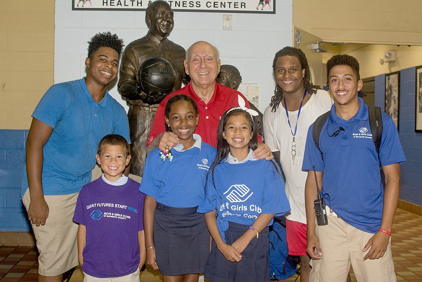 Demen, Landen, Brianna, Melanie, Keenan and Alex pose with Dick Vitale before Vitale awarded five club members with $1,000 scholarships.