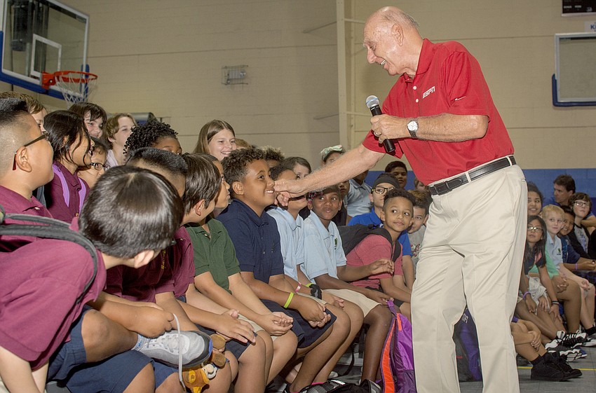 Dick Vitale teases a club member after awarding five $1,000 scholarships. Vitale encouraged the children to chase their dreams.