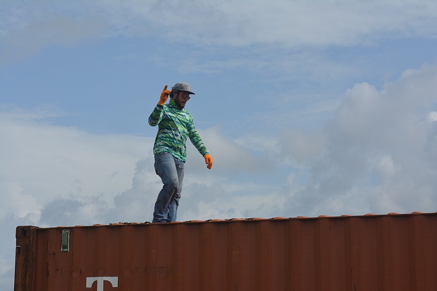 Skylar Bragg signals to his DNJ Crane coworkers.