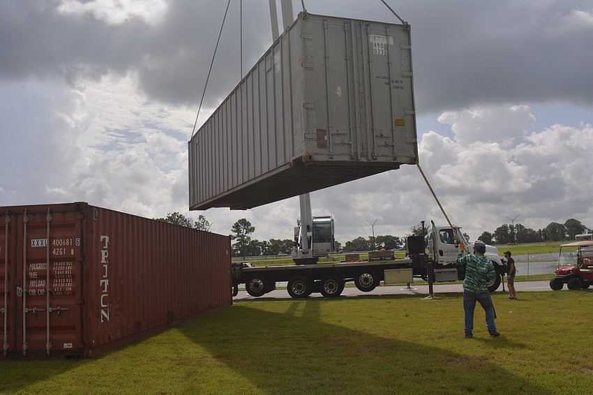 Skylar Bragg corrals a shipping crate.