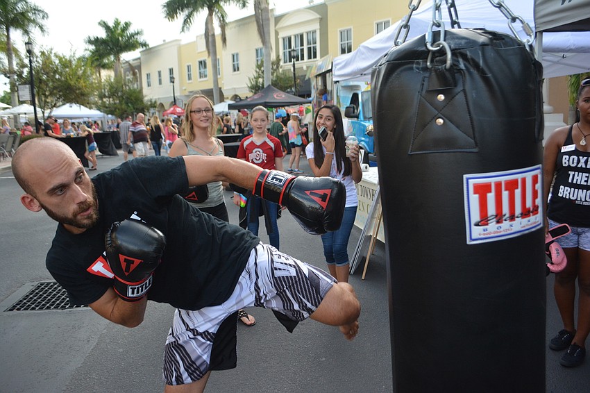 Trainer Bobby Wynarczuk gives the Music on Main crowd a hard-hitting demonstration of what you get at Sarasota's Title Boxing Club.