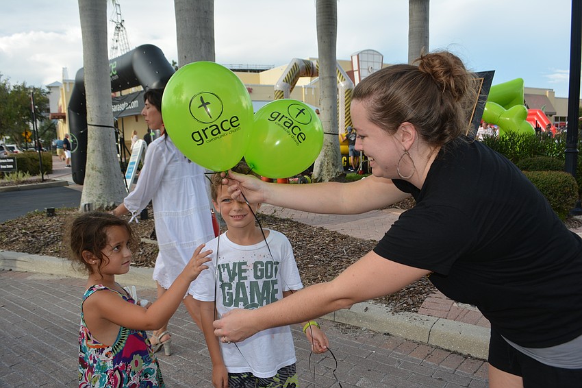 Maya and Gavin Petricca of Lakewood Ranch get some bonus balloons from Grace Community Church's Michelle Bennett.