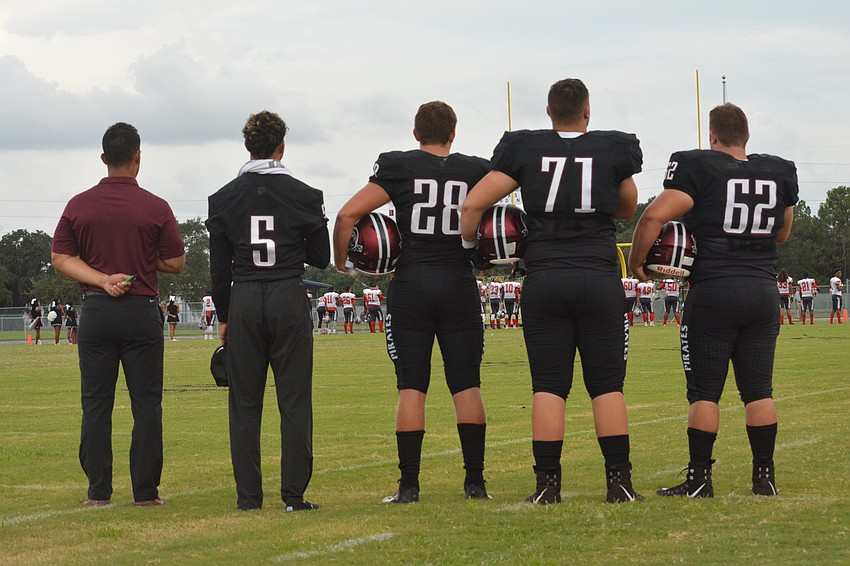 Curt Bradley and game captains Tyrone Collins, Travis Tobey, Brendan Bengtsson and Luke Andrews stand for the National Anthem.