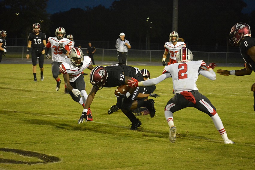 Knowledge McDaniel stumbles forward after making a catch.