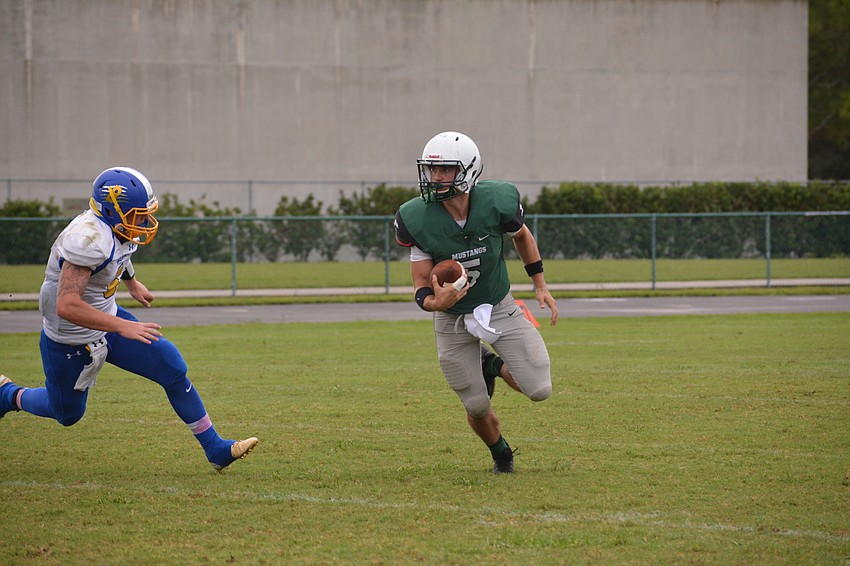 Justin Curtis scrambles to his left.