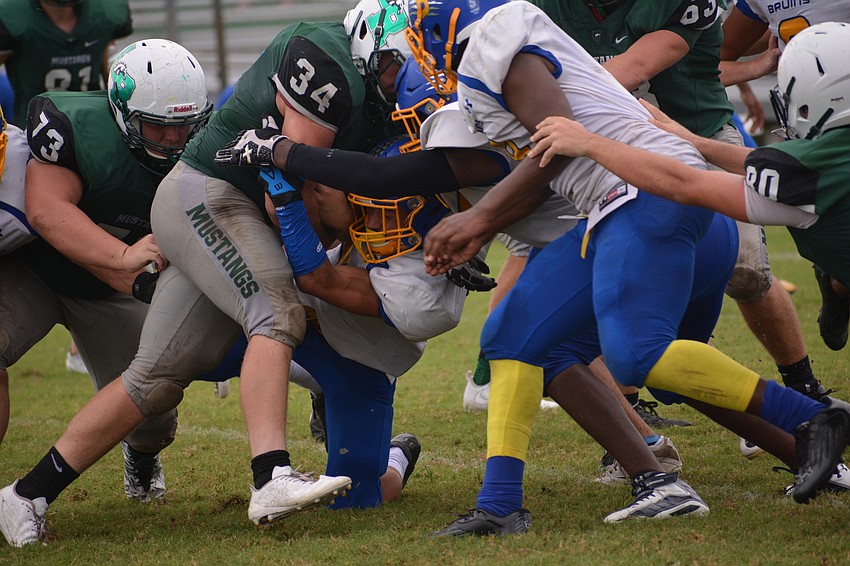 Chase Sharp (34) pounds into the middle of the Bayshore defense.