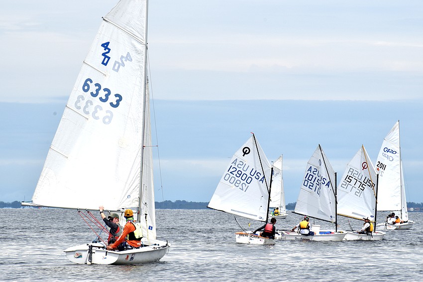 Despite the races being postponed, sailors headed out on the water to wait for the wind to pick up.