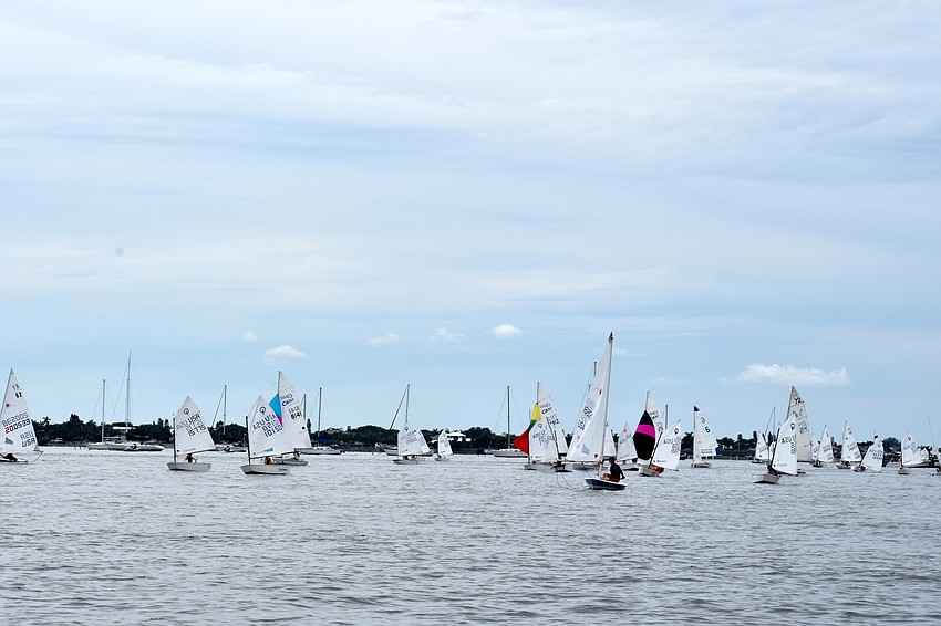 Despite the races being postponed, sailors headed out on the water to wait for the wind to pick up.