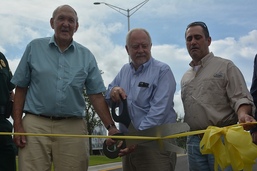 Former SMR CEO John Clark, current SMR CEO Rex Jensen and Sarasota County Commissioner Paul Caragiulo do the honors as the Lorraine Road extension opens.