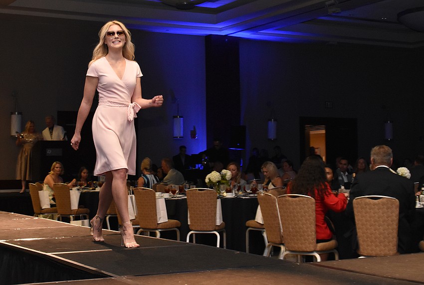 Sarah Harrington shows off a pink Camilyn Beth dress during the Women’s Council of Realtors Sarasota 2017 Fashion Show: “The Pieces Make the Whole” on Sept. 6 at Hyatt Regency Sarasota.