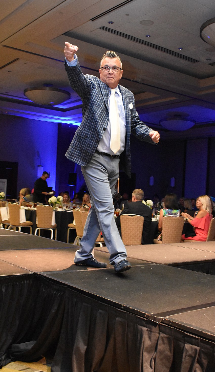 Douglas Fedish works the crowd during the Women’s Council of Realtors Sarasota 2017 Fashion Show: “The Pieces Make the Whole” on Sept. 6 at Hyatt Regency Sarasota.