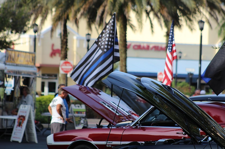 Show cars sit on Main Street at Lakewood Ranch with an American theme.