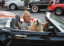 Lakewood Ranch's Steve Kulp drives into the Wednesday car show at Lakewood Main Street with his pooch, Abby.