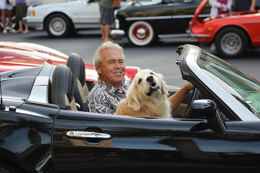 Lakewood Ranch's Steve Kulp drives into the Wednesday car show at Lakewood Main Street with his pooch, Abby.