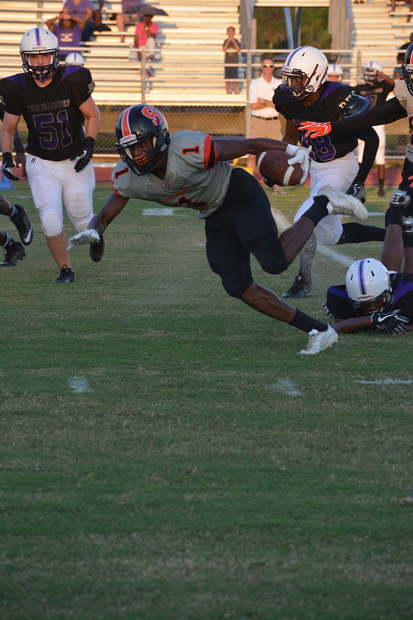 Sarasota's Charles Ward stumbles to the ground during a kick return.