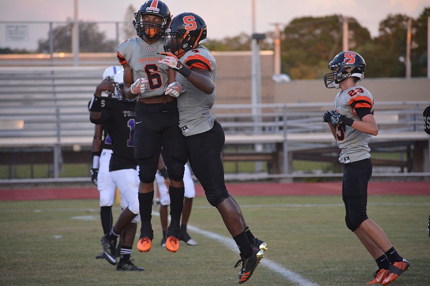 Sarasota's Brian Battie and Deric DuBose air bump after a DuBose touchdown.