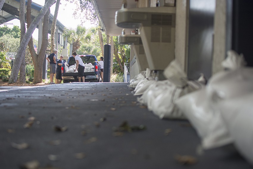 About a dozen upper-school students helped fill 300 sandbags Friday morning to fortifying the school’s doors and entrances.