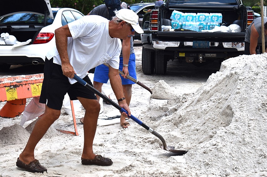 Bill Willmeth shovels sand in preparation for Hurricane Irma.