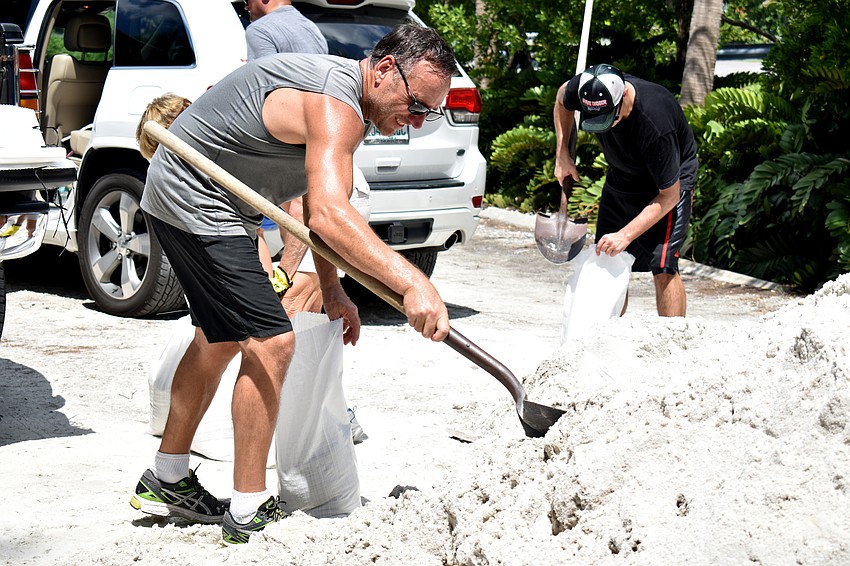 Jim Smith shovels sand in preparation for Hurricane Irma.