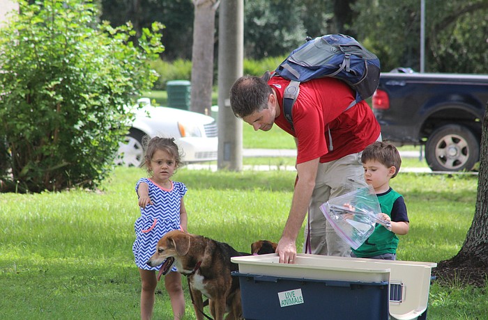East County's Nina, Toby (the dog), James and Noah Klepek gather their belongings before entering an emergency shelter at Carlos E. Haile Middle School.