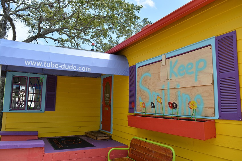 The Tube Dude's shop stayed boarded up Monday.