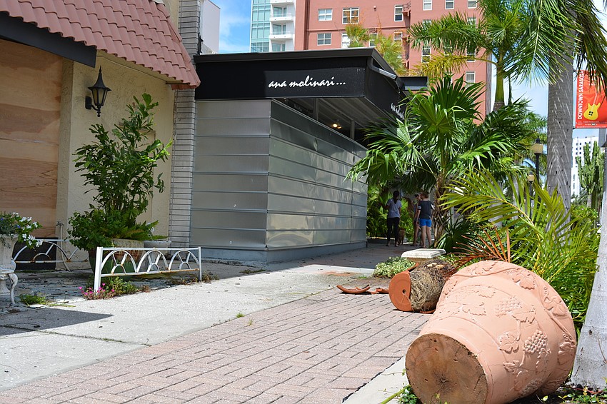 Debris littered Palm Avenue Monday, including broken planters.