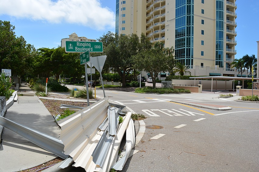 Debris piled on the corner of the roundabout of Pineapple Avenue and Ringling Boulevard Monday morning.