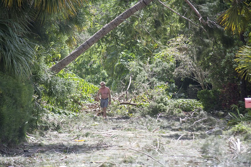 ​Peter Hull surveys the damage on Ogden Street on north Siesta Key.