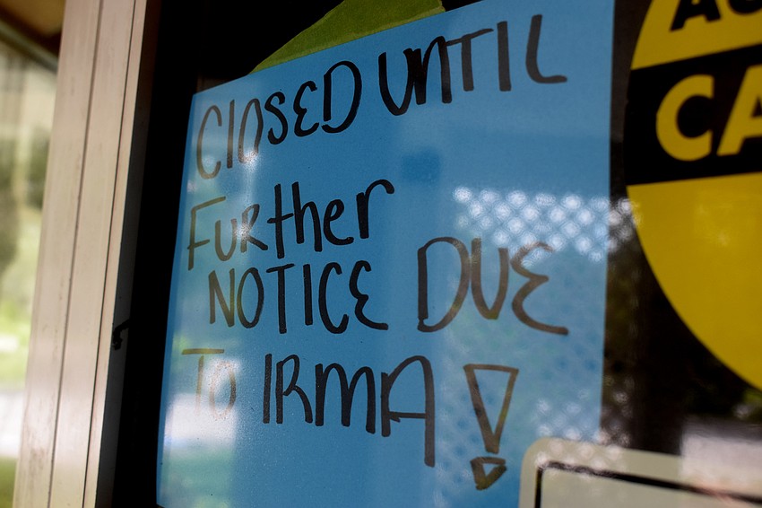 A sign hung on the inside of the entrance to the Blue Dolphin Cafe in the Centre Shoppes of Longboat Key.  Photo by Katie Johns