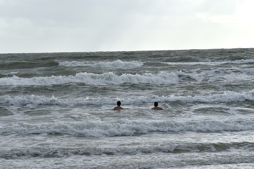 Beachgoers brave the choppy Gulf of Mexico water off Lido Key Beach. Photo by Katie Johns