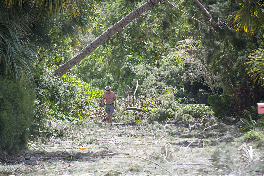 ​Peter Hull surveys the damage on Ogden Street on north Siesta Key.