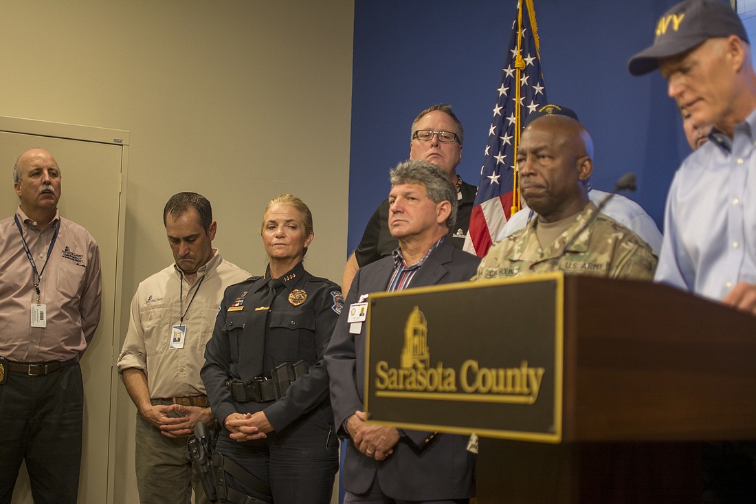 Local officials â€” including (from left) county Emergency Management Chief Ed McCrane, County Commission Chairman Paul Caragiulo  and Sarasota Police Chief Bernadette DiPino, looked on as Gov. Rick Scott spoke about Hurricane Irma.