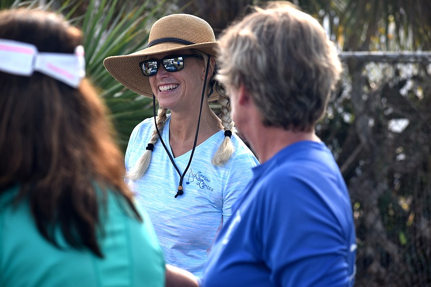 Erica Budslick smiles as she cleans up the Sarasota Sailing Squadron with fellow Luffing Lassies.