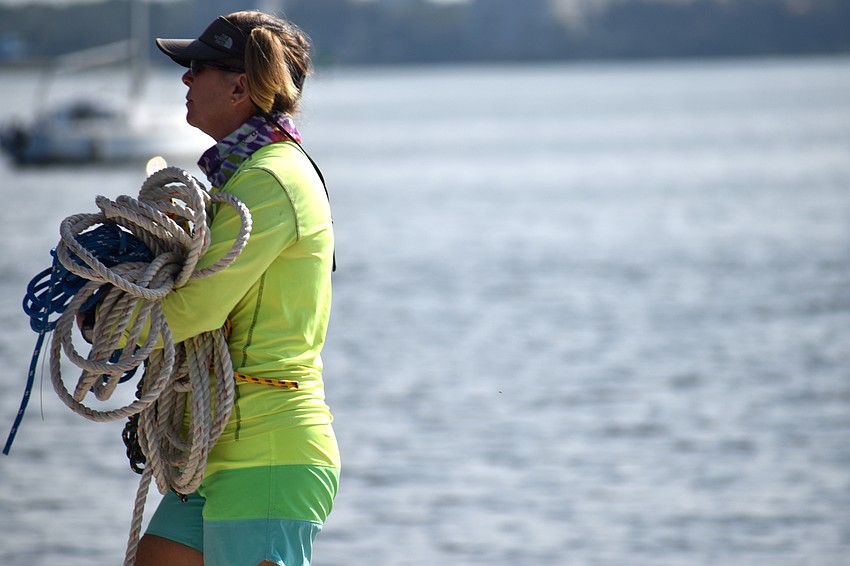 Julie Forbes carries rope while helping clean up the Sarasota Sailing Squadron.