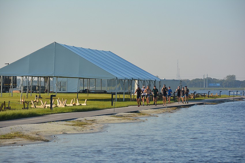 Elite rowers don't just row. A group went through a long jog before hitting the water.