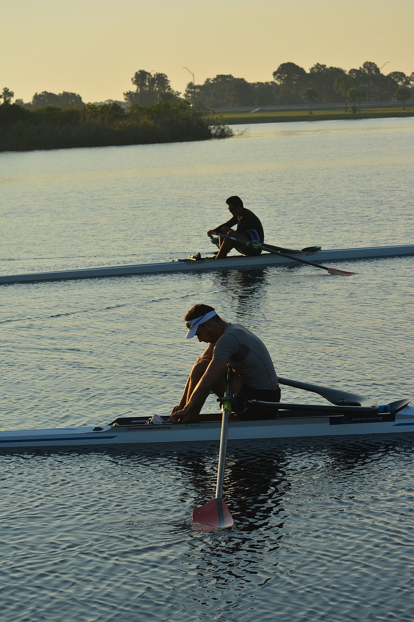 As the sun rises, rowers prepare for their practice session at Nathan Benderson Park.