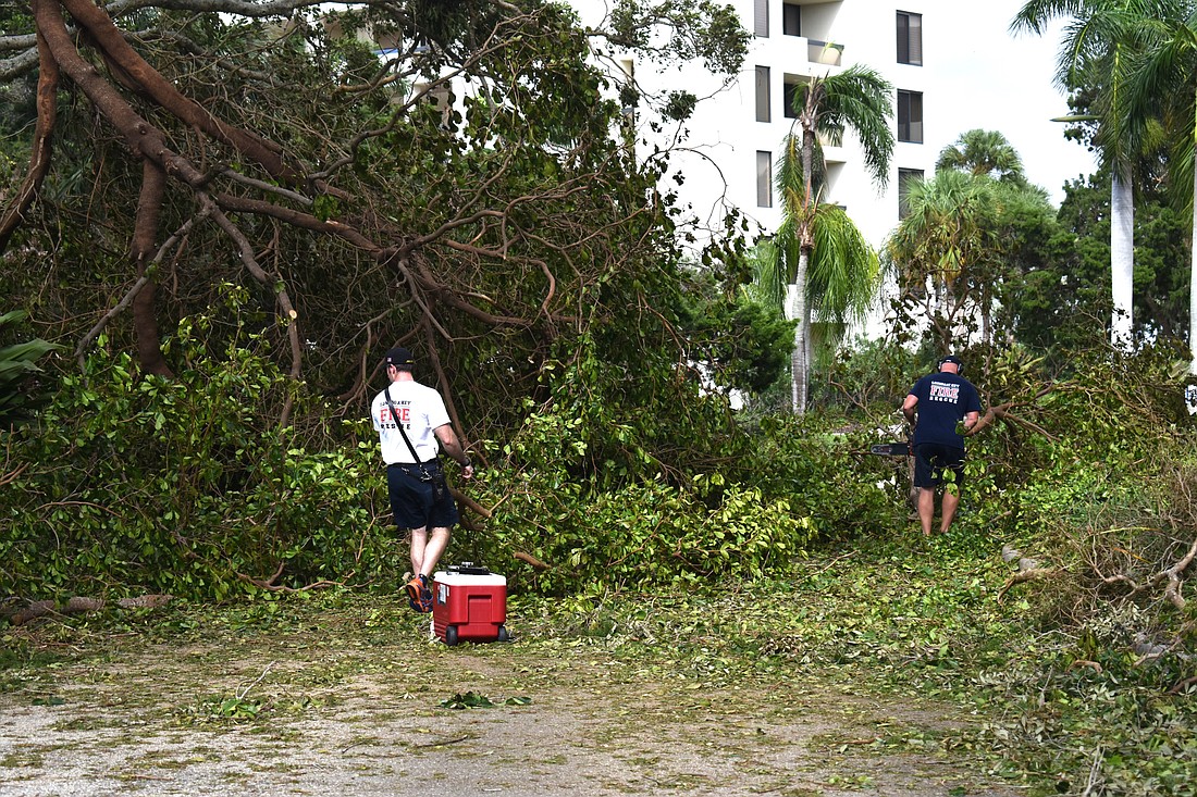 Members of Longboat Key Fire-Rescue work to begin clearing roads in the aftermath of Hurricane Irma.