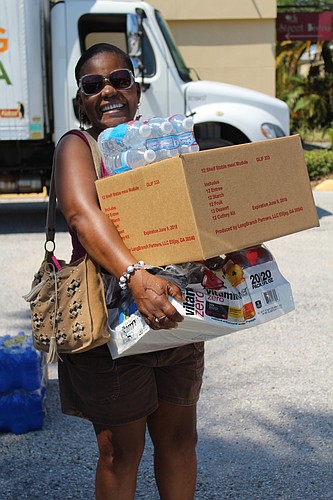 Bradentonâ€™s Valerie Marin brings food and water to her car.