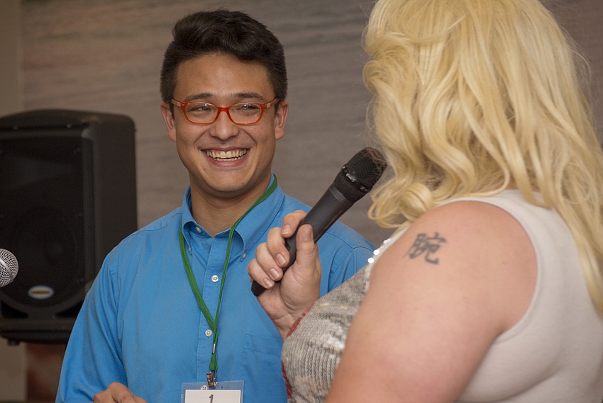 Contestant Rob Young laughs during as Miss Beneva Fruitville introduces him to the audience.