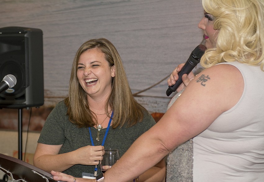 Jamie Minton laughs during Miss Beneva Fruitville's introduction.