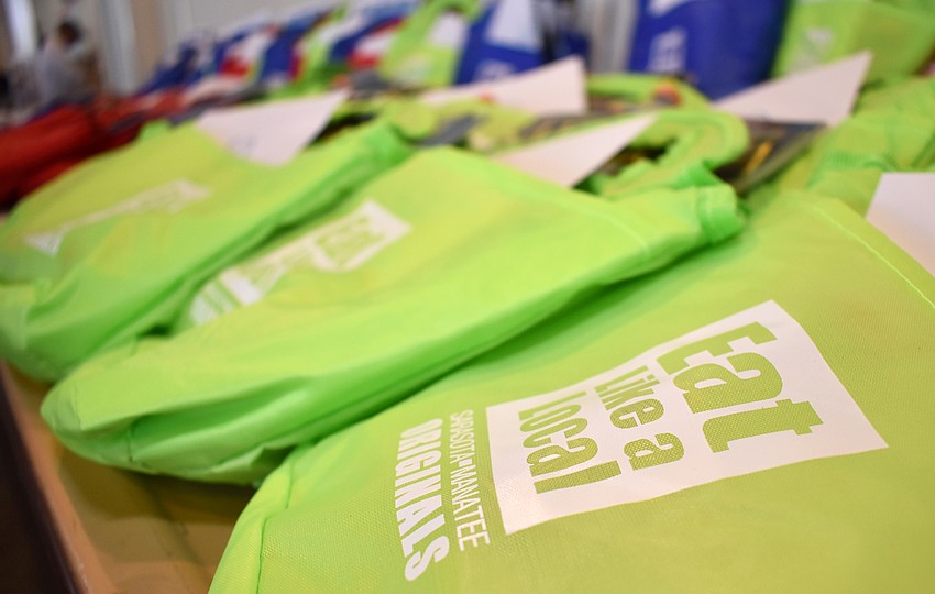 Rows of goodie bags lined the table closest to the exit at the Eat Like a Local Restaurant Week Kickoff Event on Sept. 20 at Keating Marine Education Center.