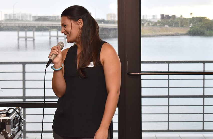 Sarasota-Manatee Originals Executive Director Sarah Firstenberger laughs during her welcome speech at the Eat Like a Local Restaurant Week Kickoff Event on Sept. 20 at Keating Marine Education Center.