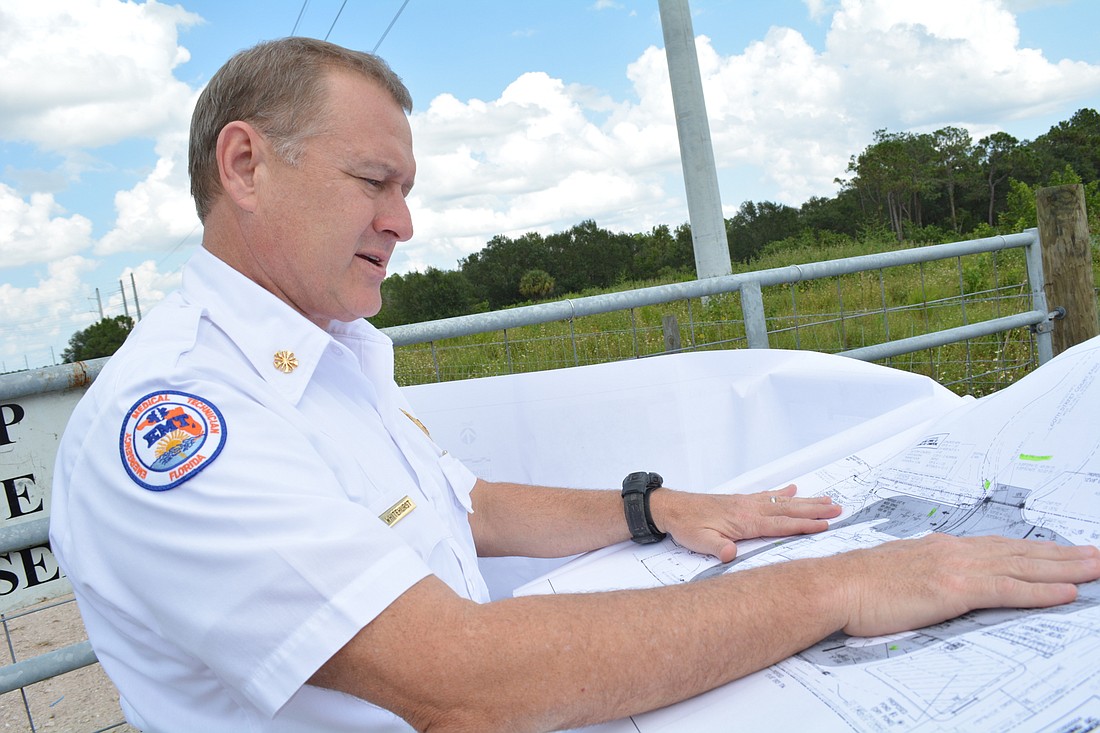 East Manatee Fire Rescue Chief Lee Whitehurst pulls out plans for Station 2 at the future site for Station 7. The fire district will have to select and architect and engineer for the project, but the facilities could be similar.