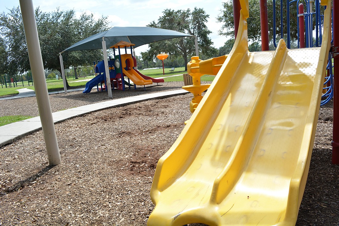 The playground shade structure, pictured behind, was slashed by vandals. Lakewood Ranch Community Development District 4 supervisors hope forthcoming policies will reduce vandalism.