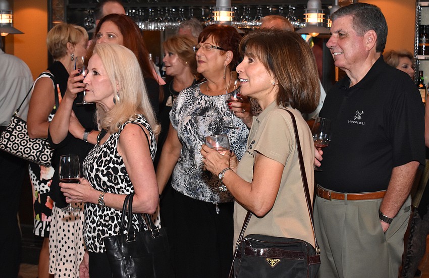 Guests eagerly view the slideshow of photos from their South Africa trip.